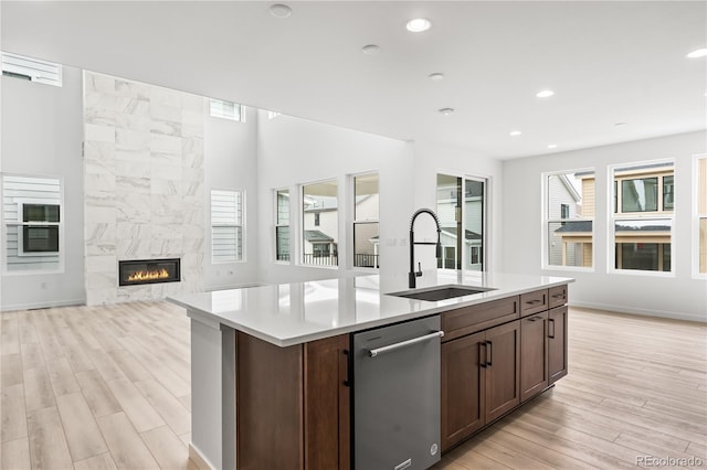 8850 Moonshimmer Trl, Littleton, CO 80125 - kitchen with stainless steel dishwasher, light wood-style flooring, open floor plan, light countertops, and recessed lighting