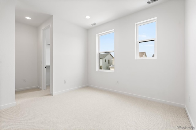 8850 Moonshimmer Trl, Littleton, CO 80125 - spare room featuring light colored carpet and recessed lighting