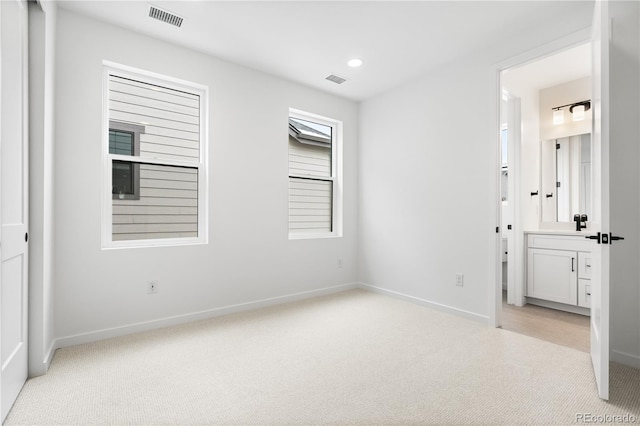 8850 Moonshimmer Trl, Littleton, CO 80125 - unfurnished bedroom featuring light carpet, recessed lighting, and ensuite bathroom