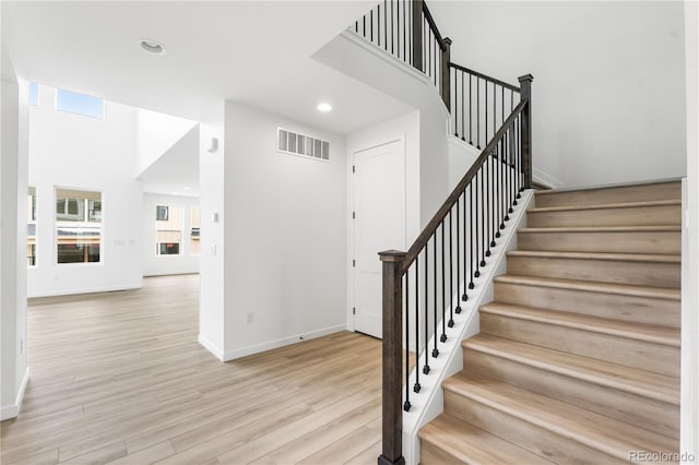 8850 Moonshimmer Trl, Littleton, CO 80125 - stairway with wood finished floors and recessed lighting