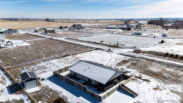 snowy aerial view featuring a rural view