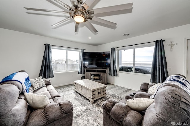 living room featuring ceiling fan and light wood-type flooring