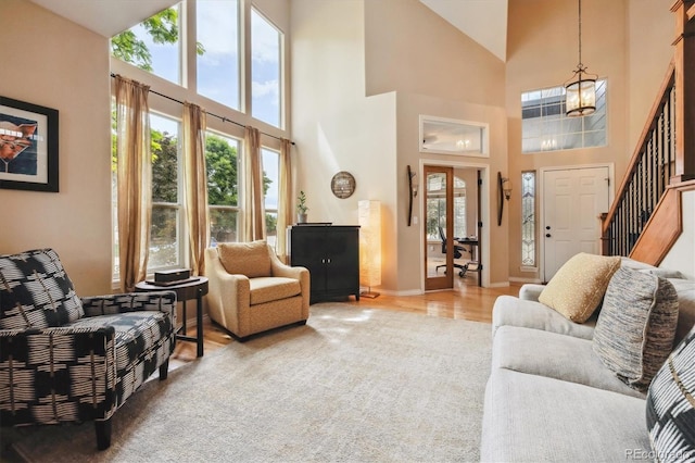 9478 Burgundy Cir, Highlands Ranch, CO 80126 - living area with a towering ceiling, a chandelier, stairs, and light wood-type flooring