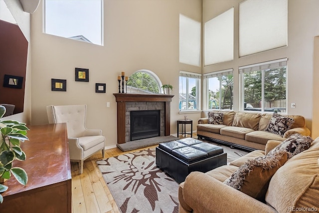 9478 Burgundy Cir, Highlands Ranch, CO 80126 - living room featuring a towering ceiling, a fireplace, and light wood-style flooring