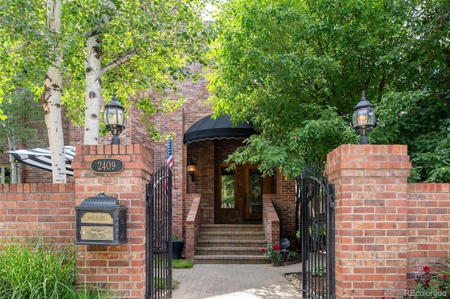 2409 E Cedar Ave, Denver, CO 80209 - view of front of house with a gate and brick siding