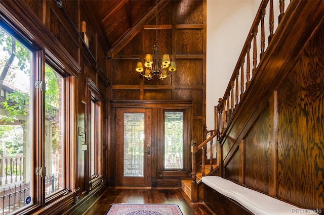 2409 E Cedar Ave, Denver, CO 80209 - foyer entrance featuring stairway, dark wood-style floors, a chandelier, wood walls, and high vaulted ceiling