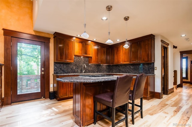 2409 E Cedar Ave, Denver, CO 80209 - kitchen with light wood-type flooring, healthy amount of natural light, recessed lighting, and backsplash