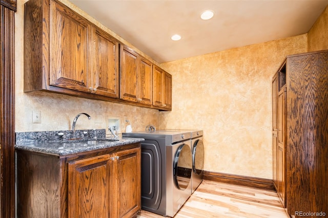 2409 E Cedar Ave, Denver, CO 80209 - washroom featuring cabinet space, light wood-type flooring, independent washer and dryer, recessed lighting, and a textured wall