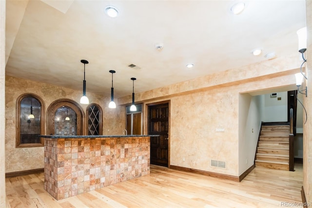 2409 E Cedar Ave, Denver, CO 80209 - indoor bar with light wood finished floors, stairs, and hanging light fixtures