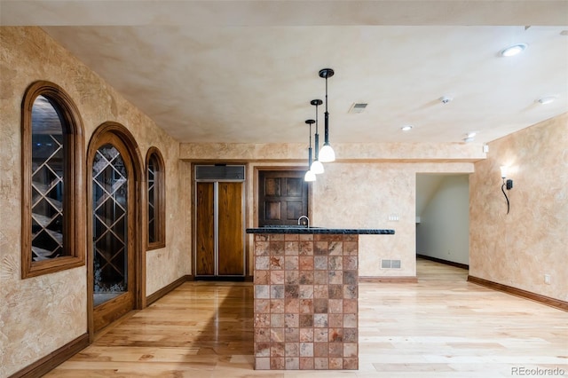2409 E Cedar Ave, Denver, CO 80209 - wine room featuring light wood-style flooring and bar area