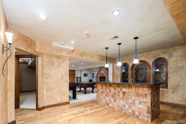 2409 E Cedar Ave, Denver, CO 80209 - bar area with light wood-style floors, pool table, decorative light fixtures, recessed lighting, and a stone fireplace