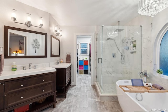 bathroom with vanity, wood-type flooring, and independent shower and bath