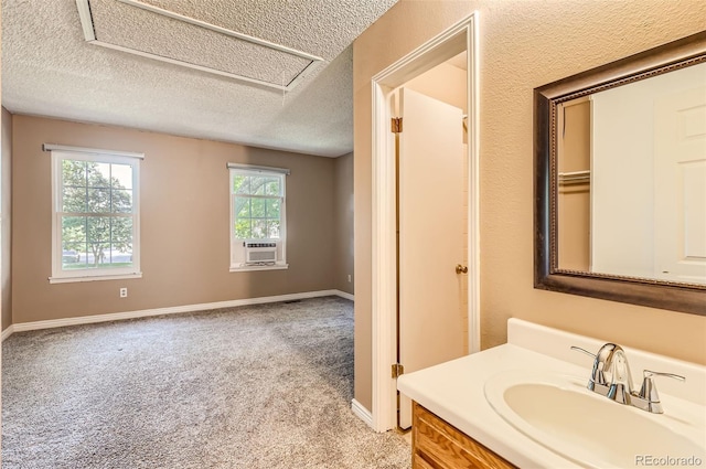 bathroom featuring baseboards, vanity, and a textured ceiling