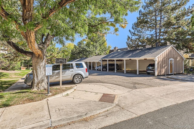 view of vehicle parking featuring a carport