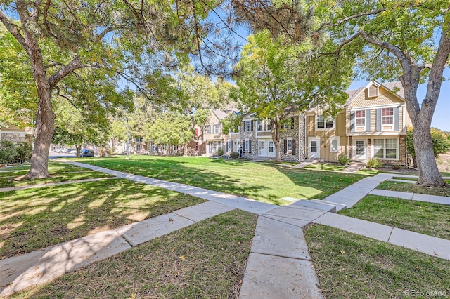 view of home's community with a lawn