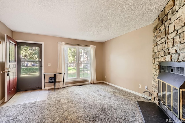 unfurnished living room with a fireplace, light carpet, and a textured ceiling