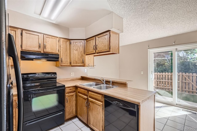 kitchen with sink, black appliances, a textured ceiling, light tile patterned flooring, and kitchen peninsula