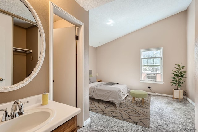 bathroom with lofted ceiling, vanity, cooling unit, and a textured ceiling