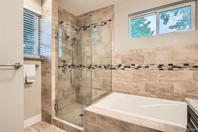1916 S Elati St, Denver, CO 80223 - full bathroom featuring a shower stall and a garden tub