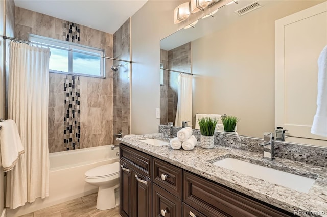 1916 S Elati St, Denver, CO 80223 - bathroom with double vanity, shower / bathtub combination with curtain, and wood finished floors