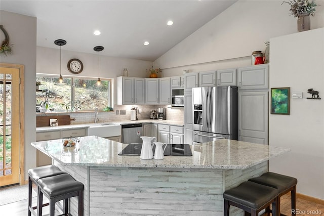2230 County Road 72, Bailey, CO 80421 - kitchen with appliances with stainless steel finishes, tasteful backsplash, a sink, a kitchen breakfast bar, and light stone countertops