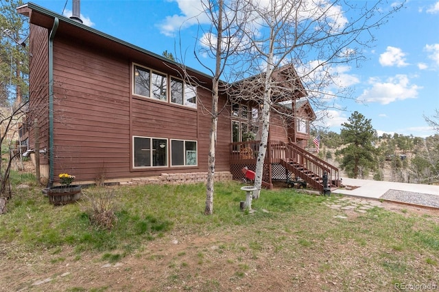 2230 County Road 72, Bailey, CO 80421 - view of home's exterior with stairway, a yard, and a wooden deck