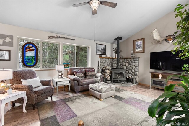 2230 County Road 72, Bailey, CO 80421 - living area with a wood stove, lofted ceiling, wood finished floors, and ceiling fan