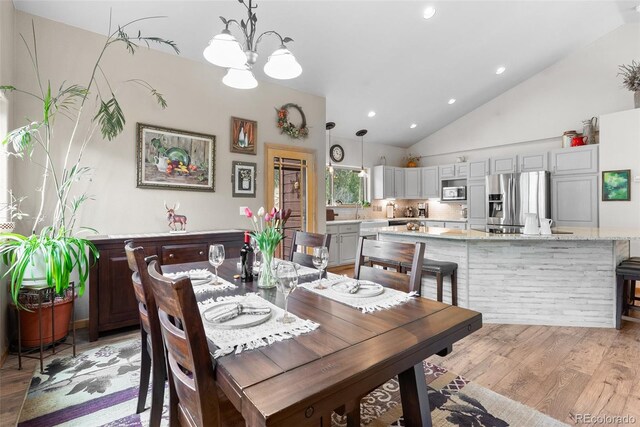 2230 County Road 72, Bailey, CO 80421 - dining room featuring a chandelier, vaulted ceiling, light wood-style floors, and recessed lighting