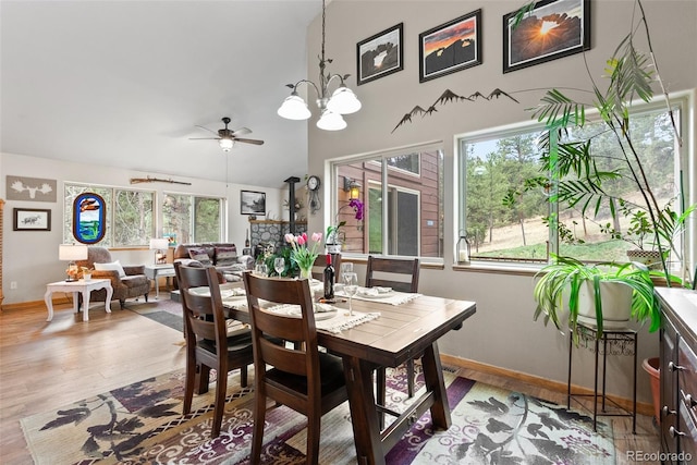 2230 County Road 72, Bailey, CO 80421 - dining room featuring wood finished floors, a chandelier, baseboards, and a towering ceiling