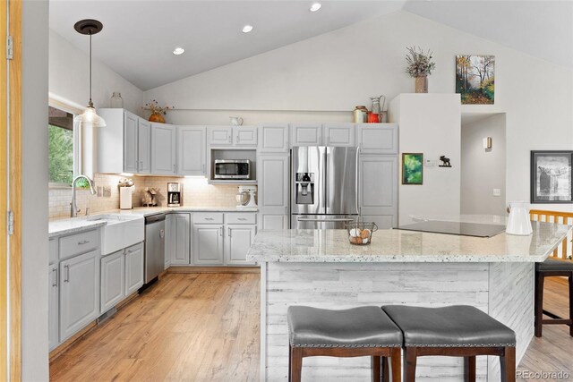 2230 County Road 72, Bailey, CO 80421 - kitchen with stainless steel appliances, tasteful backsplash, light wood-style floors, pendant lighting, and a sink