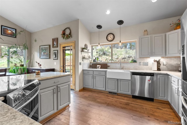 2230 County Road 72, Bailey, CO 80421 - kitchen featuring stainless steel appliances, a sink, gray cabinets, healthy amount of natural light, and vaulted ceiling