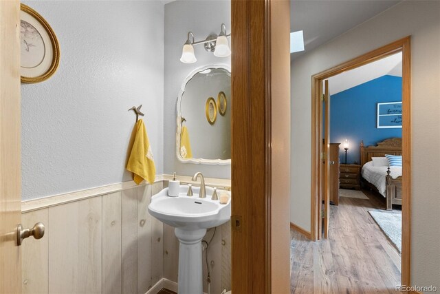 2230 County Road 72, Bailey, CO 80421 - bathroom featuring wood finished floors and a wainscoted wall