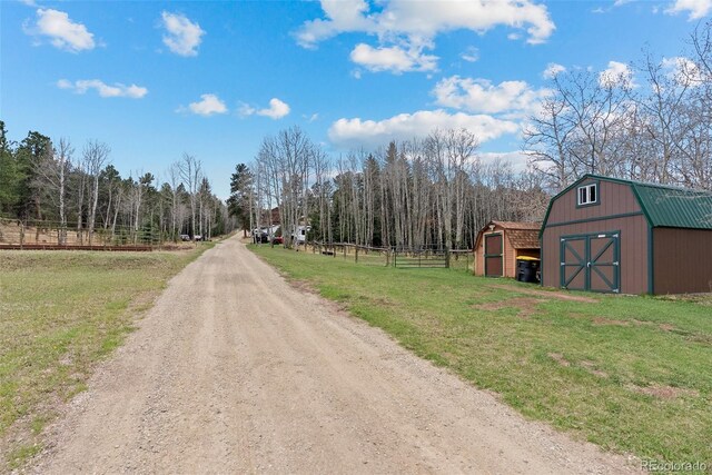 2230 County Road 72, Bailey, CO 80421 - view of dirt / gravel road with a barn and a forest view
