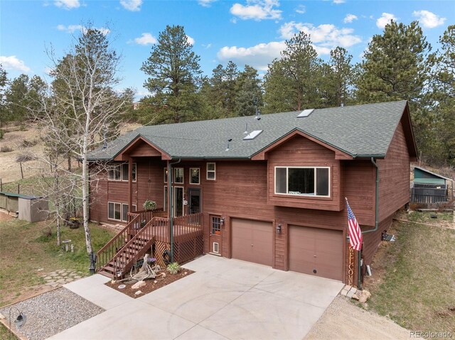 2230 County Road 72, Bailey, CO 80421 - chalet / cabin with a garage, driveway, roof with shingles, and a front lawn