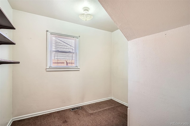 carpeted empty room featuring baseboards and visible vents