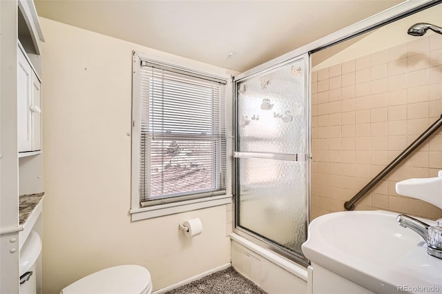 full bath featuring enclosed tub / shower combo, toilet, tile walls, and a sink