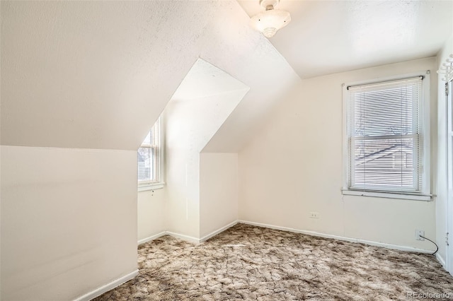 bonus room featuring carpet flooring, baseboards, and vaulted ceiling