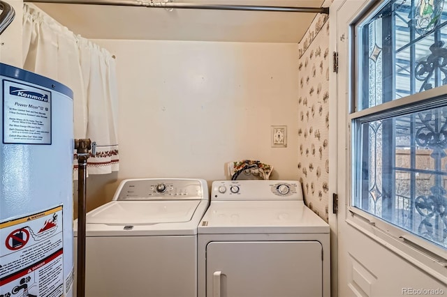 washroom featuring laundry area, washer and dryer, and gas water heater