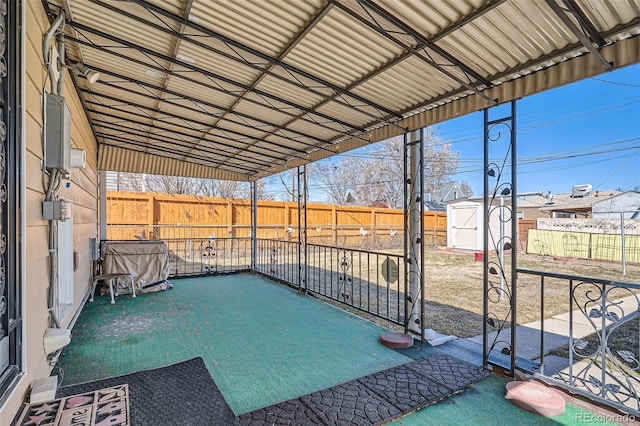 view of patio / terrace with a fenced backyard, a shed, and an outdoor structure