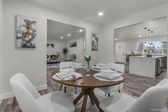 dining area featuring baseboards, recessed lighting, and wood finished floors