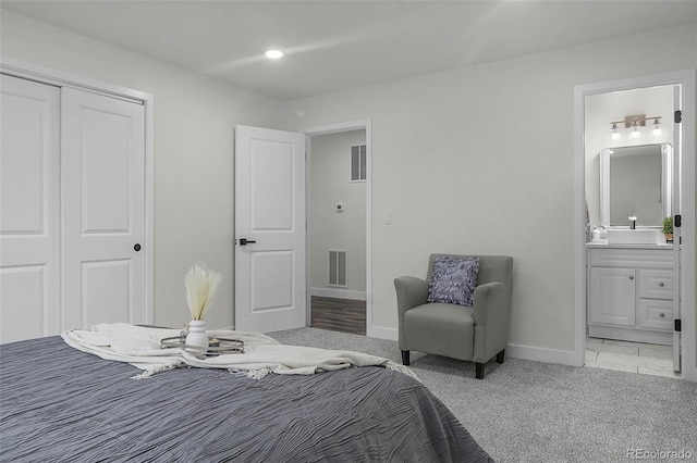 bedroom with baseboards, a closet, connected bathroom, and visible vents