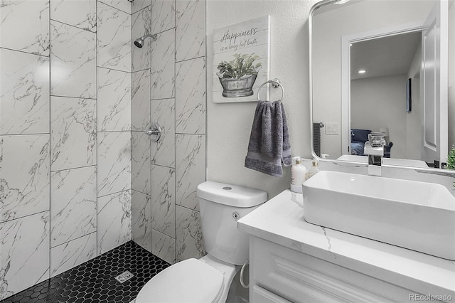 full bath featuring vanity, toilet, and a stall shower