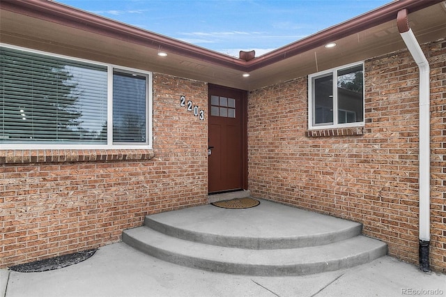 entrance to property with brick siding