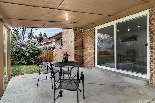 view of patio with fence and outdoor dining area