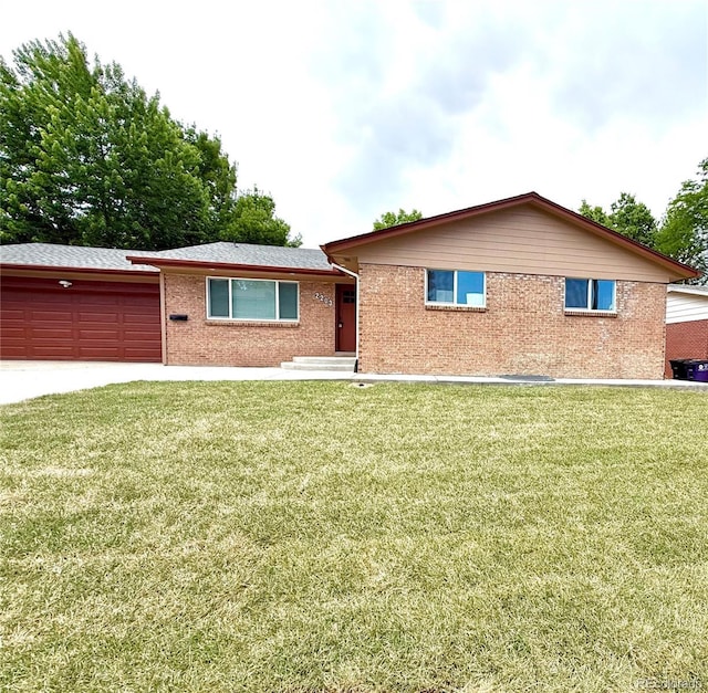 2203 S Harlan St, Denver, CO 80227 - single story home featuring a garage, brick siding, a front yard, and driveway