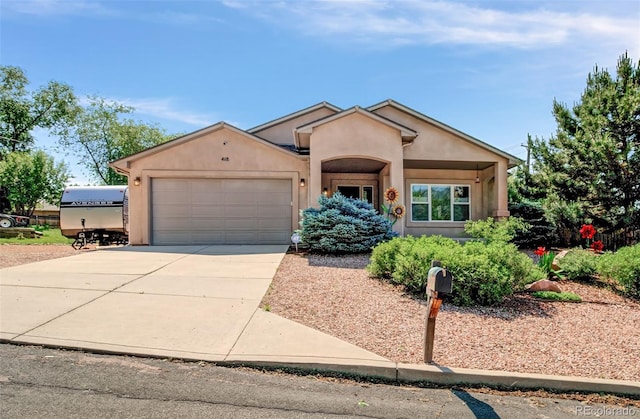 418 Hilltop Cir, Colorado Springs, CO 80905 - view of front of property featuring an attached garage, driveway, and stucco siding