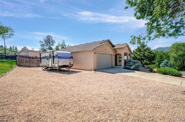 418 Hilltop Cir, Colorado Springs, CO 80905 - view of side of home featuring driveway, stucco siding, and an attached garage