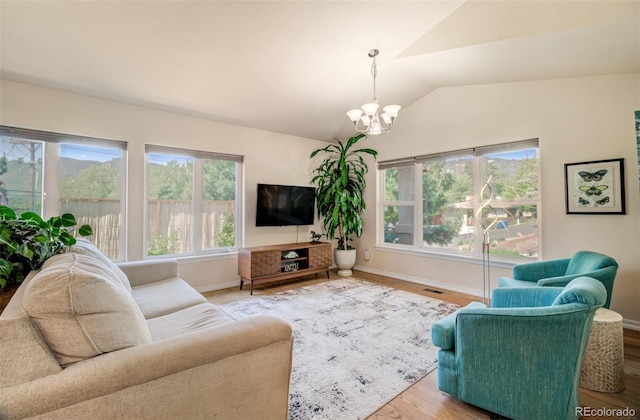 418 Hilltop Cir, Colorado Springs, CO 80905 - living area with lofted ceiling, a chandelier, and wood finished floors