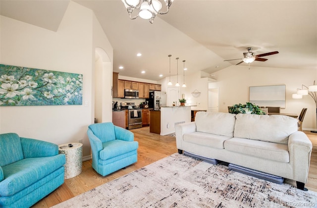 418 Hilltop Cir, Colorado Springs, CO 80905 - living room featuring lofted ceiling, light wood-style floors, a ceiling fan, recessed lighting, and a chandelier
