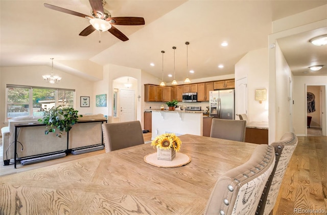 418 Hilltop Cir, Colorado Springs, CO 80905 - dining space with arched walkways, ceiling fan, lofted ceiling, light wood finished floors, and a chandelier